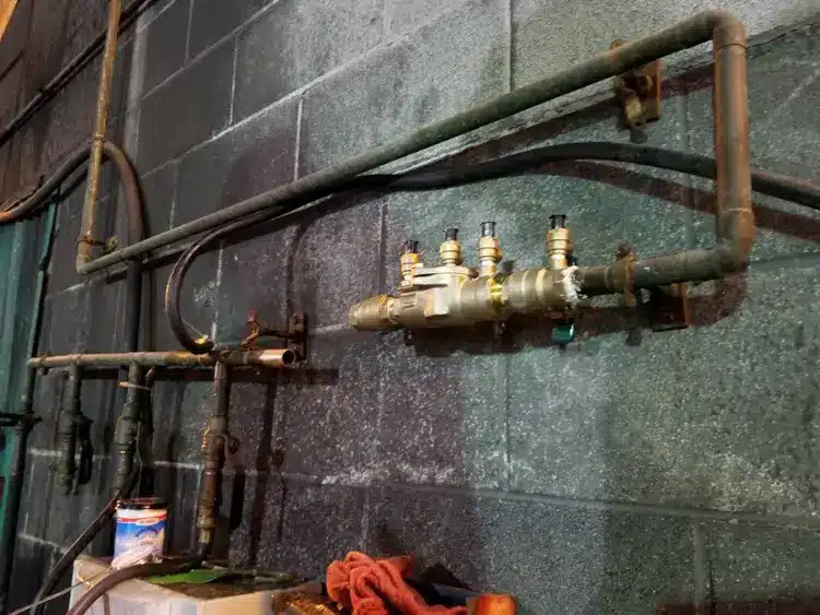 Signs of a Water Line Leak in Kansas City (and What to Do Next) 2 Corroded old galvanized steel water supply lines on a Kansas City basement wall, the aging pipe that scales shut and is a common cause of low pressure and a broken water line